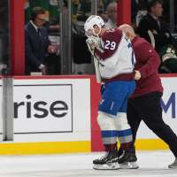 MacKinnon takes a puck from an Avs teammate to the face