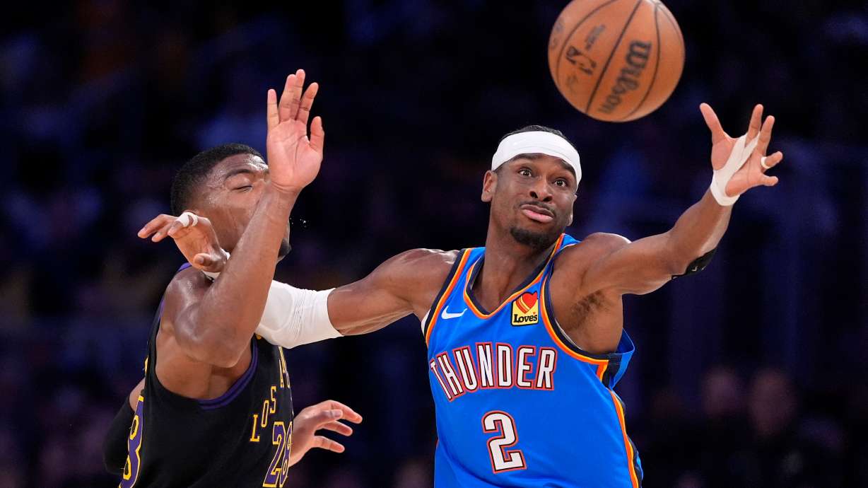 Oklahoma City Thunder guard Shai Gilgeous-Alexander, right, takes a pass while under pressure from Los Angeles Lakers forward Rui Hachimura during the first half of Game 4 in a second-round NBA basketball playoffs series Monday, May 11, 2026, in Los Angeles.