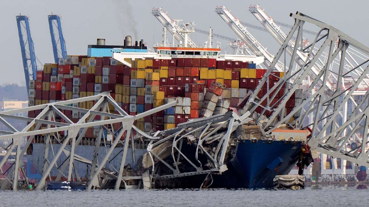 The cargo ship Dali is stuck under part of the Francis Scott Key Bridge after the ship hit the bridge, March 26, 2024, as seen from Pasadena, Md. Prosecutors have filed criminal charges against the operator of the ship.