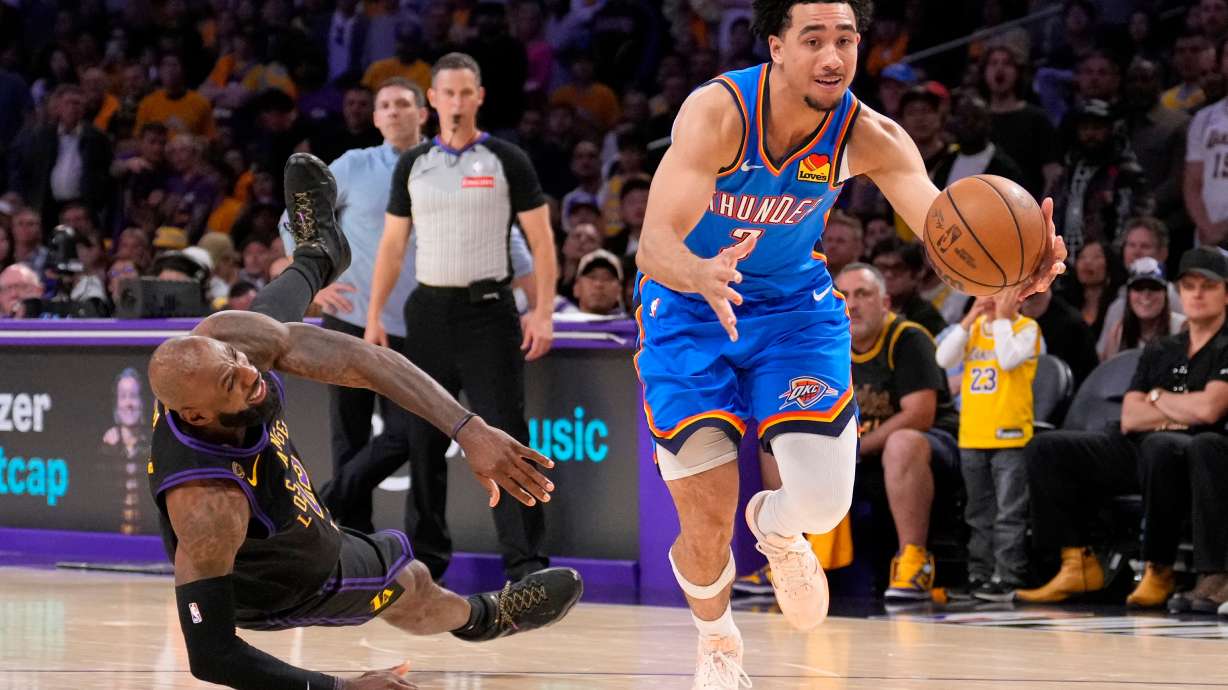 Oklahoma City Thunder guard Jared McCain, right, drives toward the basket as Los Angeles Lakers forward LeBron James falls during the second half of Game 4 in a second-round NBA basketball playoffs series Monday, May 11, 2026, in Los Angeles.