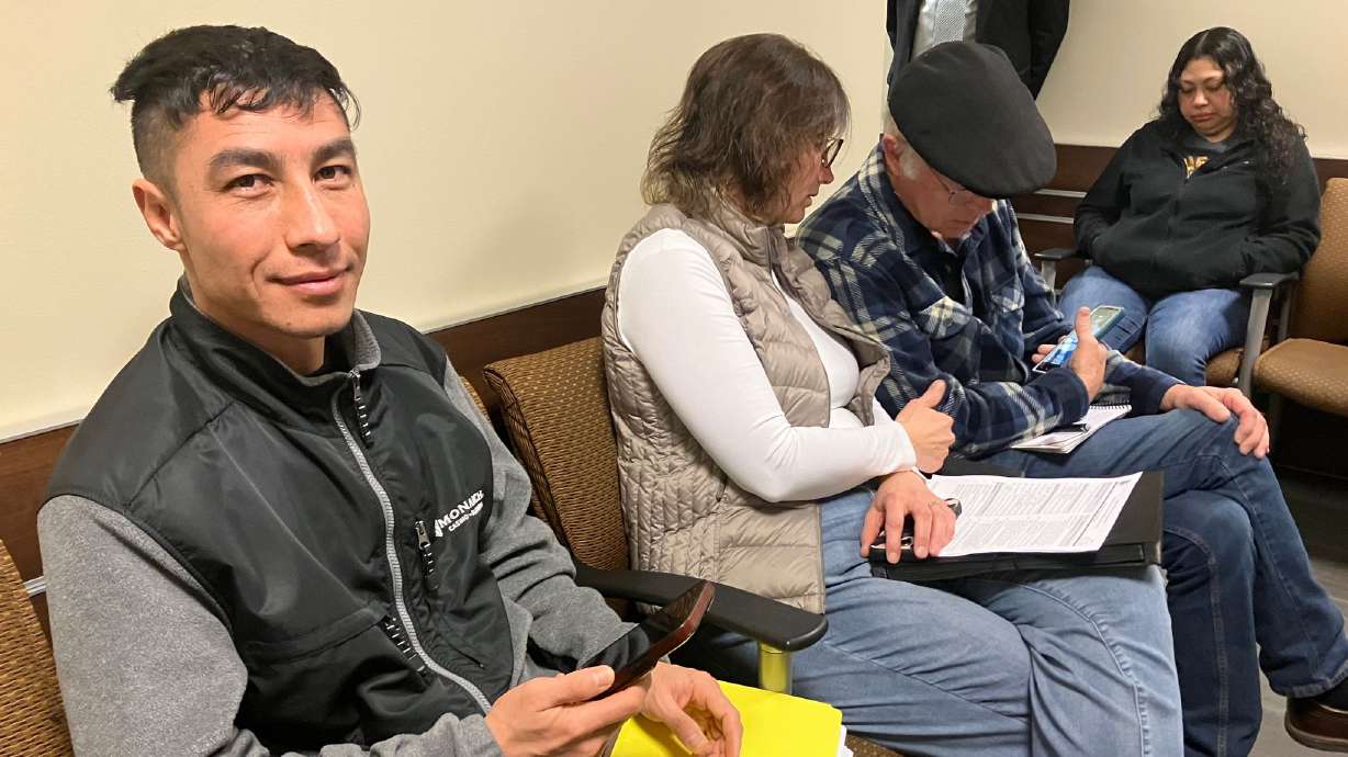 Zafar Zulfaqar checks his phone in the waiting room for his appointment with U.S. Immigration and Customs Enforcement on Feb. 12.
