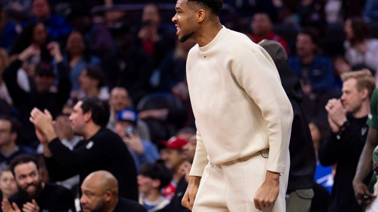 Milwaukee Bucks power forward Giannis Antetokounmpo, center, reacts from the sideline during the first half of an NBA basketball game against the Philadelphia 76ers, Sunday, April 12, 2026, in Philadelphia.