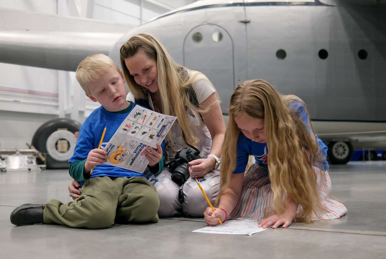Blue Star family members Oliver Johnson, Anne-Marie Johnson and Yvette Johnson do a scavenger hunt at an event to announce the Blue Star Museum program, which offers free museum access to active military personnel and their families, at the Hill Aerospace Museum at Hill Air Force Base on Tuesday. The program runs May 16-Sept. 7.