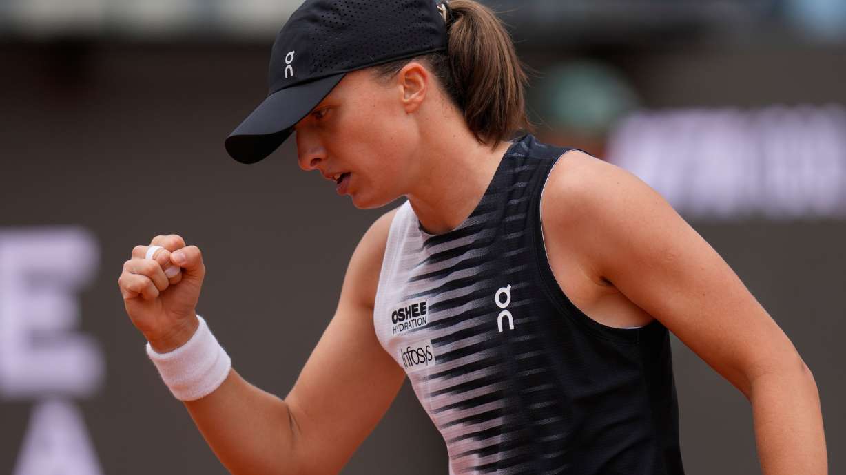 Iga Swiatek, of Poland, celebrates after wining a point during the quarter-final match against Jessica Pegula, of the United States, at the Italian Open tennis tournament in Rome, Wednesday, May 13, 2026.