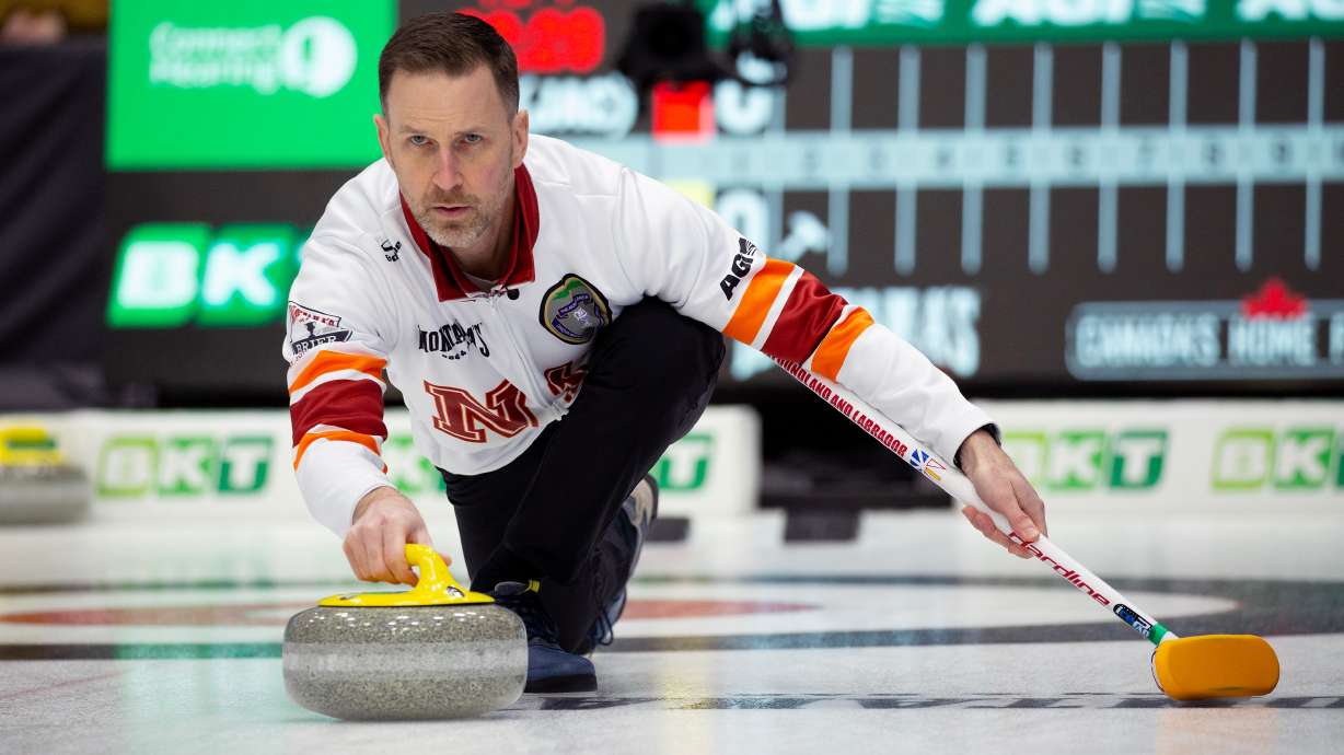 FILE - Brad Gushue, skip of Team Newfoundland and Labrador-Gushue, delivers his stone during Draw 17 at the Montana's Brier Canadian men's curling championship in St. John's, N.L., March 5, 2026.