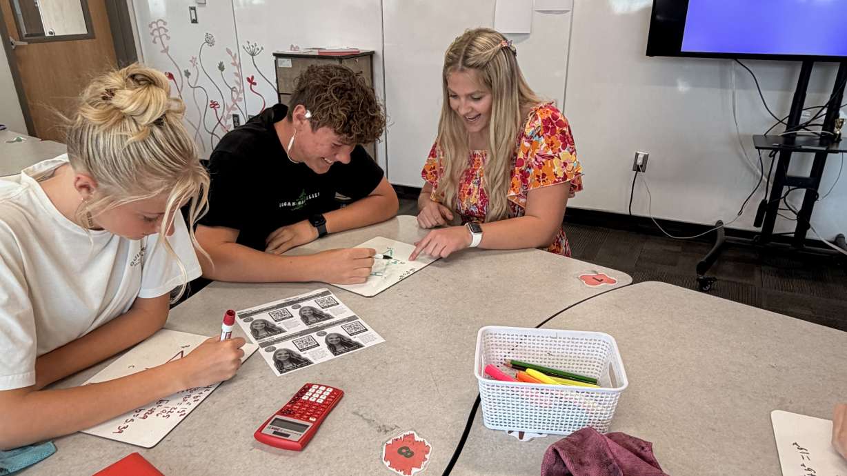 Logan High School math teacher Ryah Dowdy helps students during a class on Wednesday. Dowdy is a semifinalist in the America's Favorite Teacher competition hopes to give back to the community if she wins.
