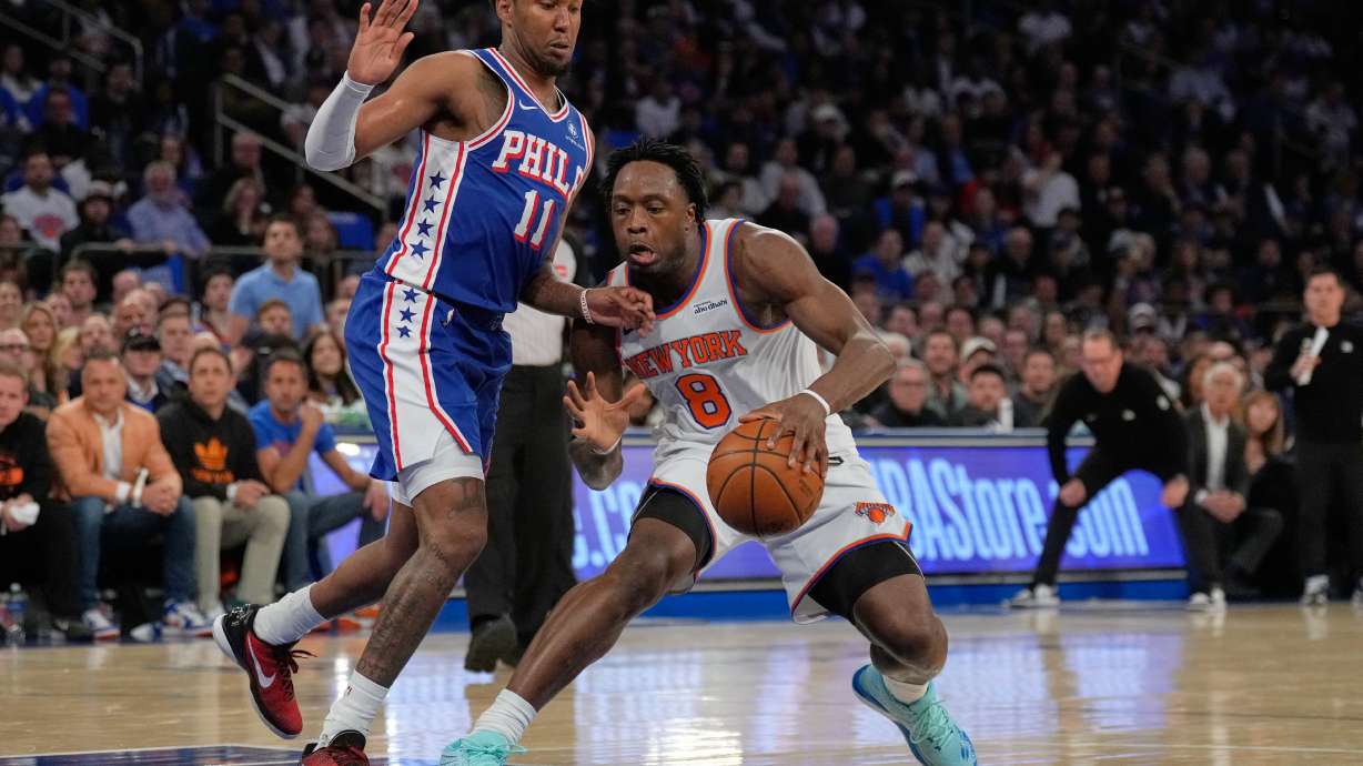 New York Knicks' Og Anunoby, right, drives past Philadelphia 76ers' Justin Edwards during the first half of Game 1 in a second-round NBA basketball playoffs series Monday, May 4, 2026, in New York.