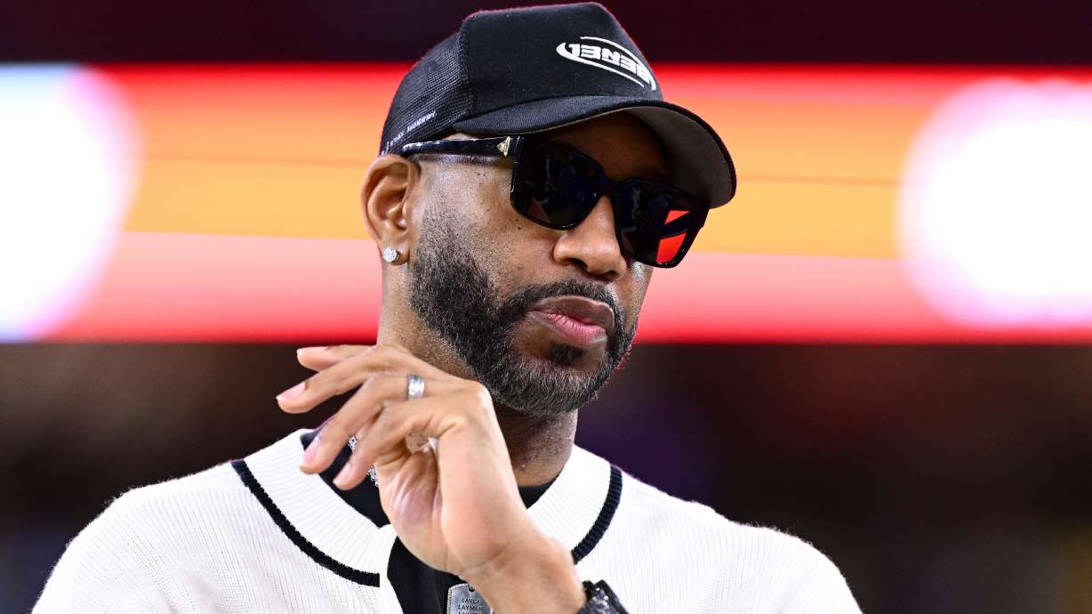 FILE - Basketball Hall of Famer Tracy McGrady stands on the sideline prior an NFL football game between the Houston Texans and the Buffalo Bills, Nov. 20, 2025, in Houston.