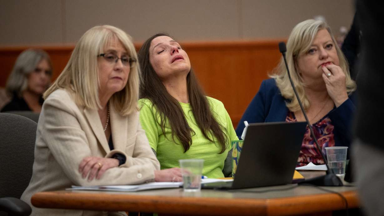 Kouri Richins, center, reacts as her brother, Ronney Darden, speaks during her sentencing in Park City Wednesday. She was sentenced to life in prison without parole in the poisoning murder of her husband.