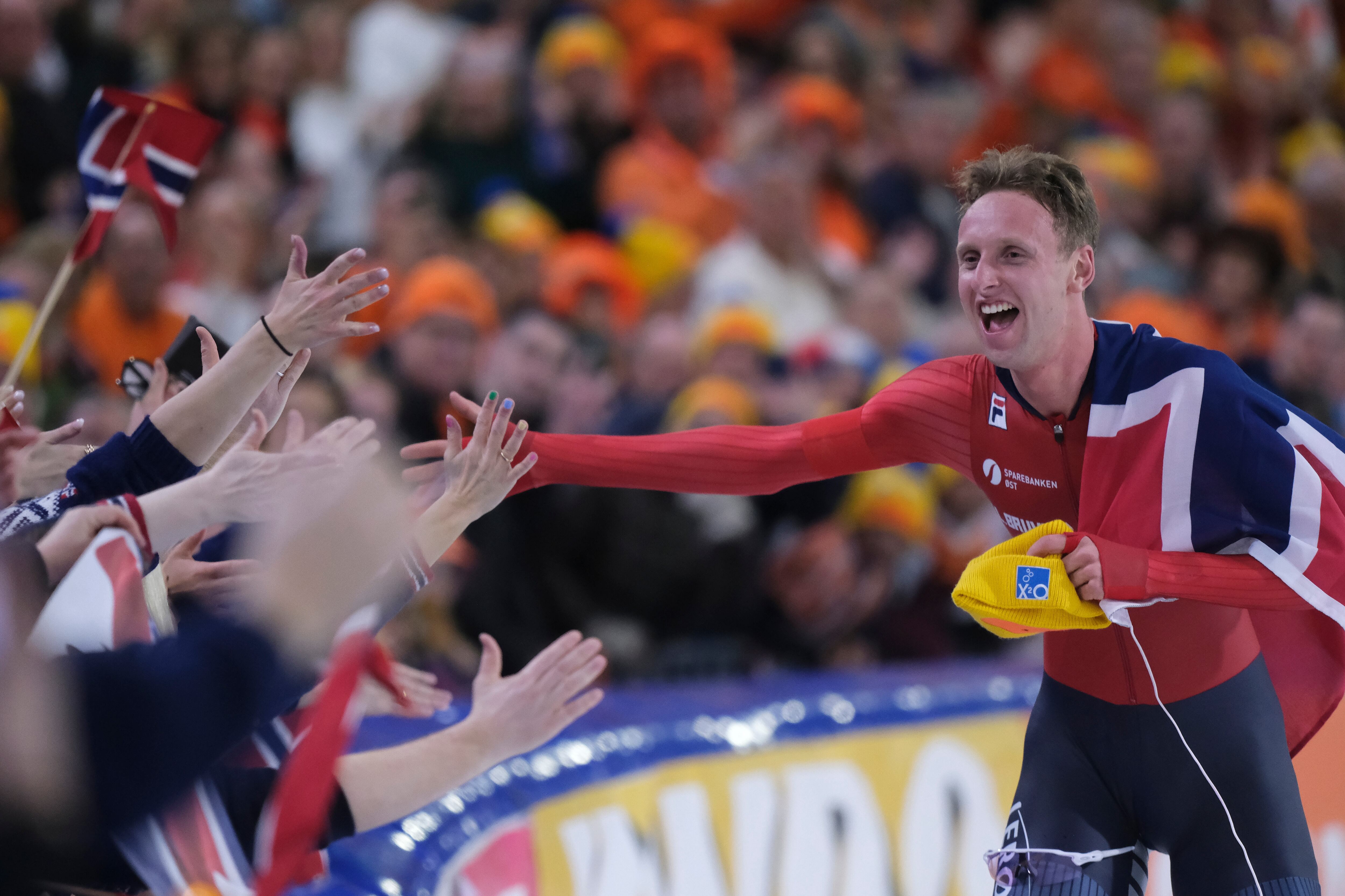 New World Champion Sander Eitrem of Norway celebrates with the fans after the men's 10000 meters speed skating race at the World Championships Allround in Heerenveen, Netherlands, March 8.