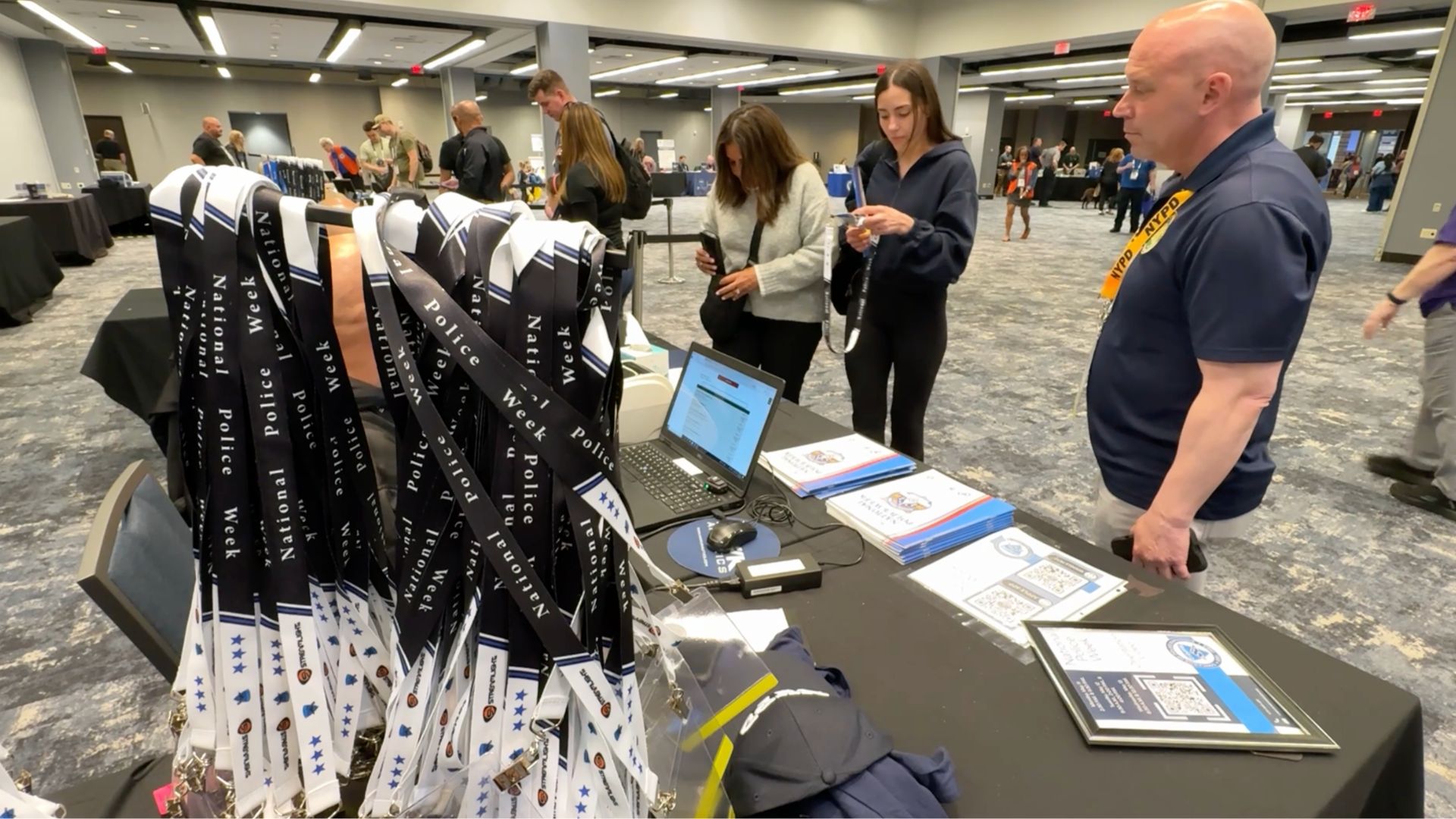 People check in at the Concerns of Police Survivors, or COPS, booth in Washington during National Police Week, Wednesday. The nonprofit supports families and coworkers of law enforcement officers killed in the line of duty.