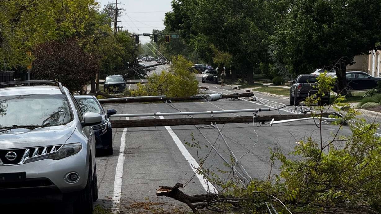 Downed power poles on Wednesday along 1700 South in Salt Lake City.