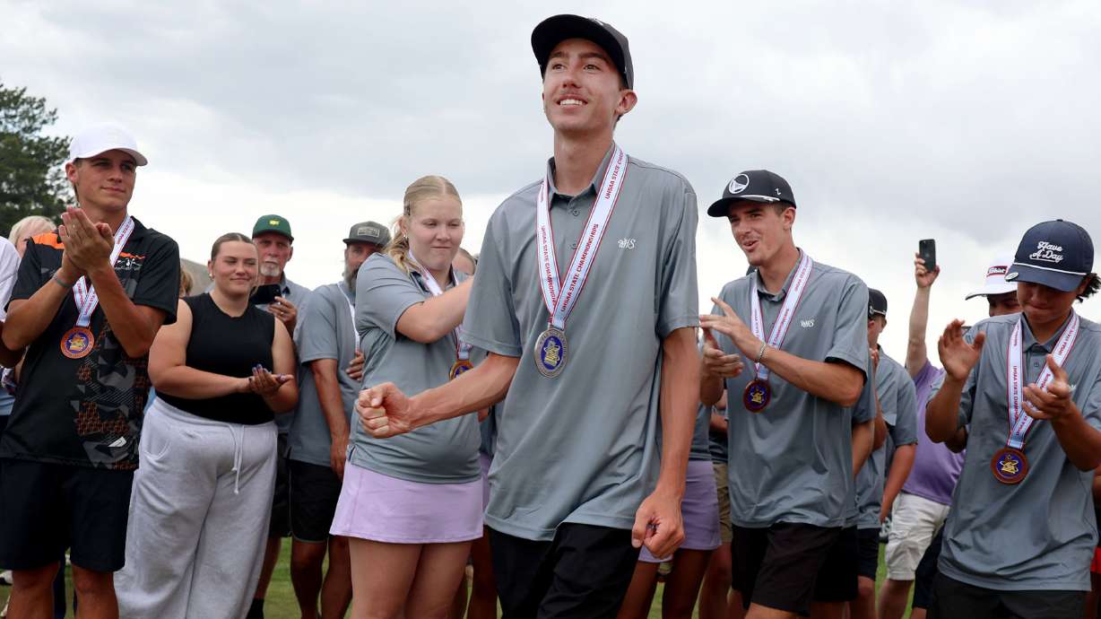 Wayne High’s Miles Hinkle, center, and teammates head to the green to accept their first place trophy in the 1A boys golf state tournament at Rose Park Golf Course in Salt Lake City on Wednesday, May 13, 2026.