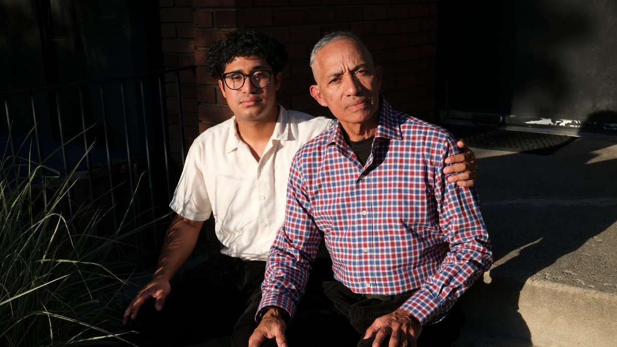 Jarod Fuentes and his father Harold Fuentes pose for a portrait outside their apartment building in Salt Lake City on May 11. They moved to the United States from Venezuela seeking asylum.