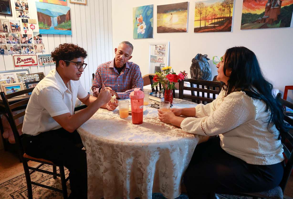 Jarod Fuentes eats dinner with his parents Harold and Maria Fuentes at home in Salt Lake City on May 11. The Fuentes moved to the United States from Venezuela seeking asylum.