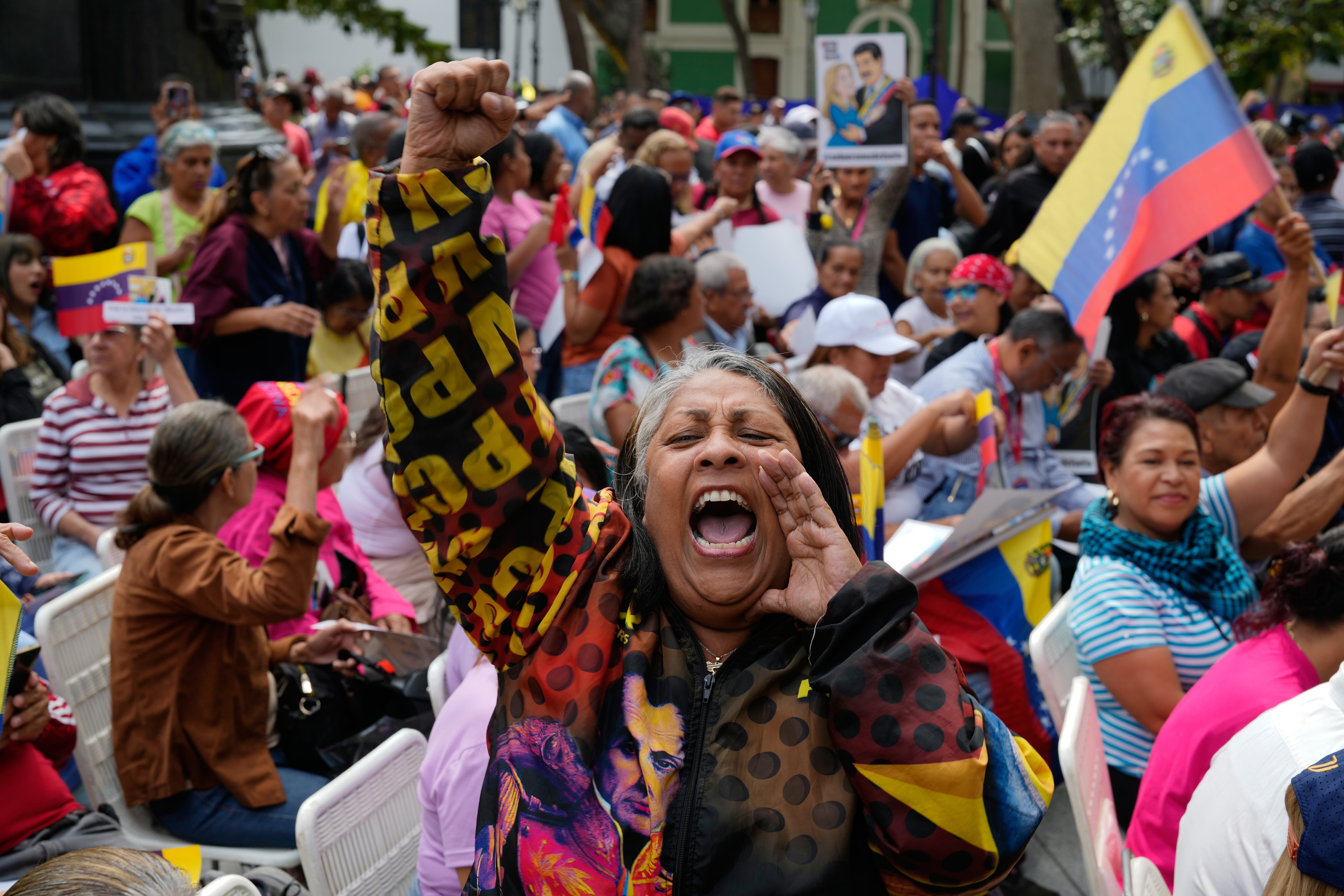 A woman screams during a government-organized event to watch former President Nicolas Maduro and first lady Cilia Flores appear in a New York court on a screen in Caracas, Venezuela, March 26.