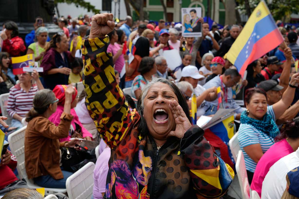 A woman screams during a government-organized event to watch former President Nicolas Maduro and first lady Cilia Flores appear in a New York court on a screen in Caracas, Venezuela, March 26.