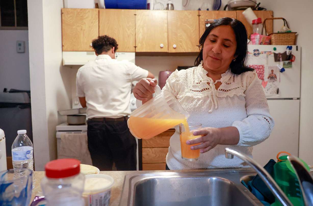 Maria Fuentes pours juice at home in Salt Lake City on May 11. The Fuentes moved to the United States from Venezuela seeking asylum.