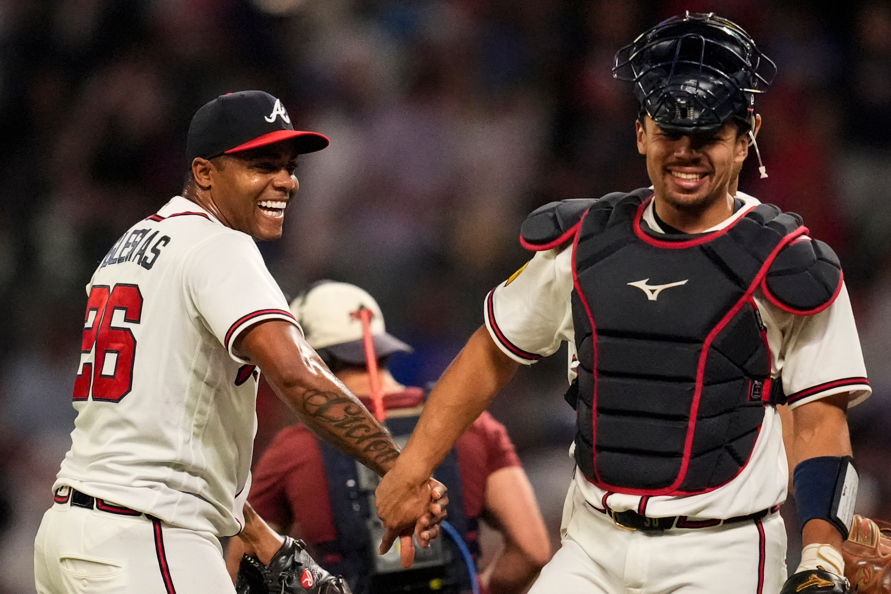 Atlanta Braves pitcher Raisel Iglesias celebrates a win over the Chicago Cubs with Drake Baldwin after a baseball game, Wednesday, May 13, 2026, in Atlanta. 