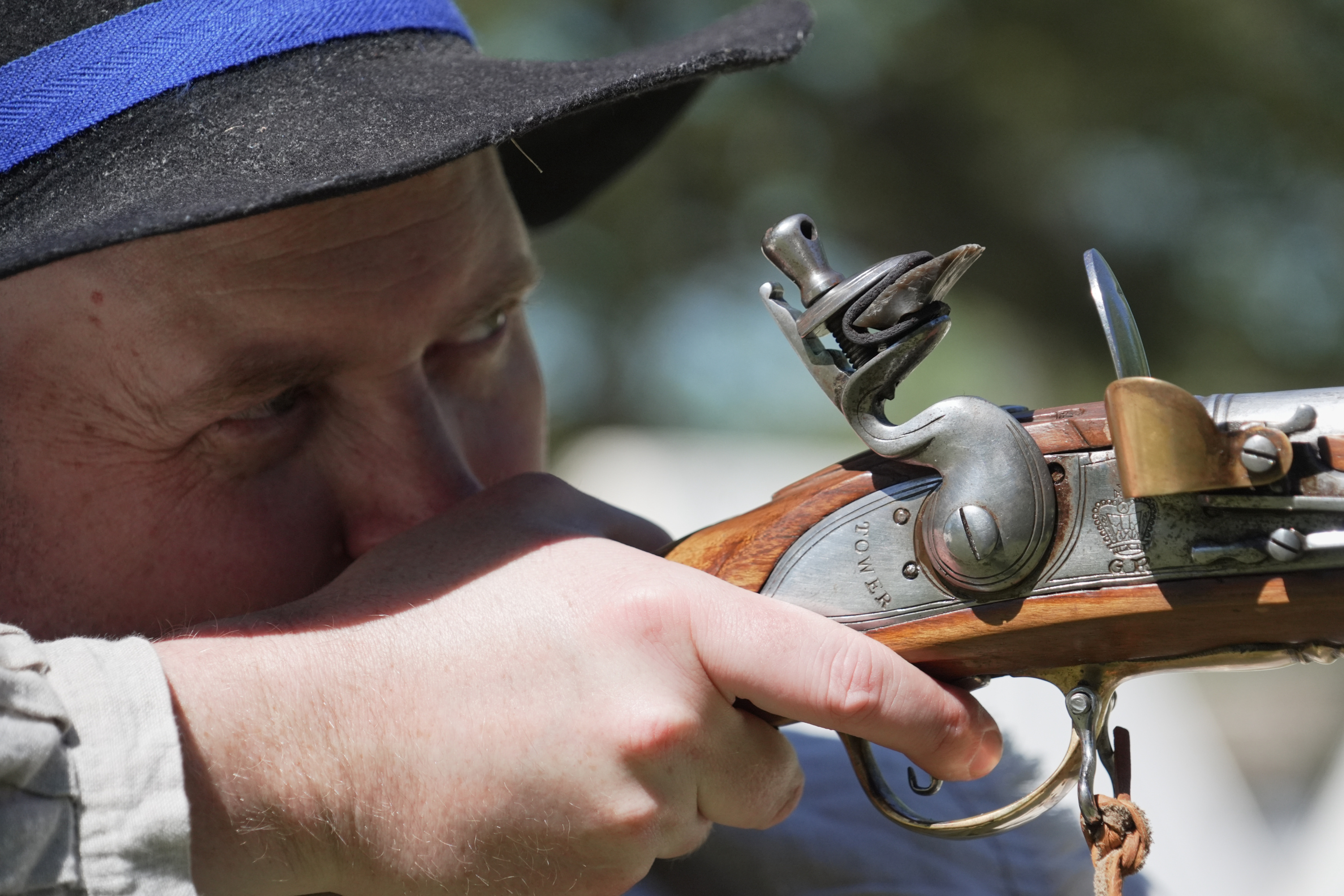 A.J. Drake, a historic interpreter, aims his Brown Bess flintlock replica musket during a Revolutionary War event in Halifax, N.C., on April 10.