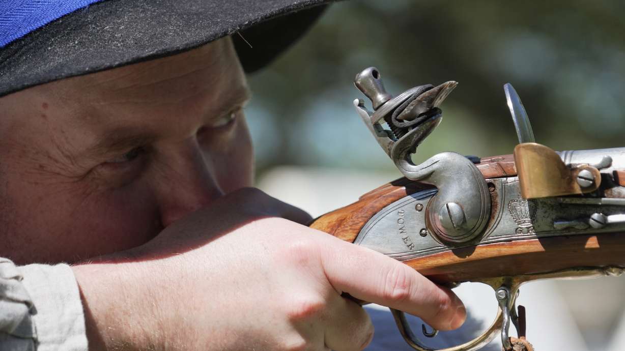 A.J. Drake, a historic interpreter, aims his Brown Bess flintlock replica musket during a Revolutionary War event in Halifax, N.C., on April 10.