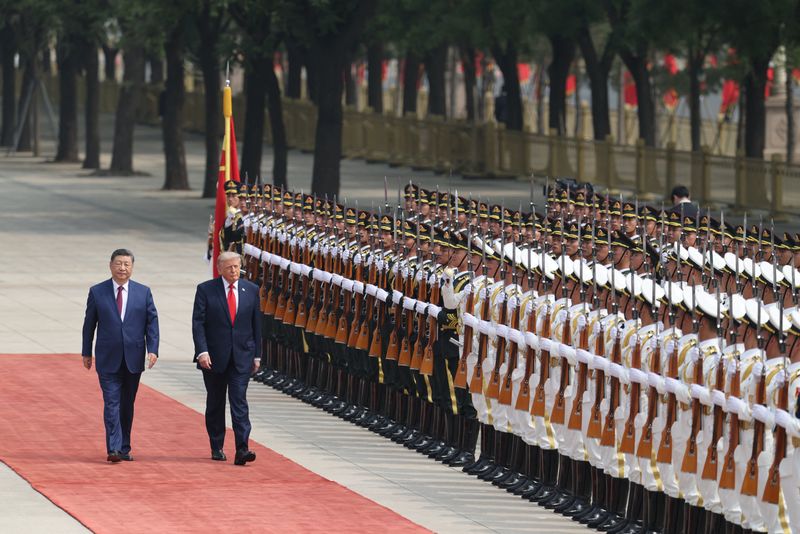 Chinese President Xi Jinping inspects an honor guard with President Donald Trump during a welcome ceremony at the Great Hall of the People, in Beijing, Thursday.