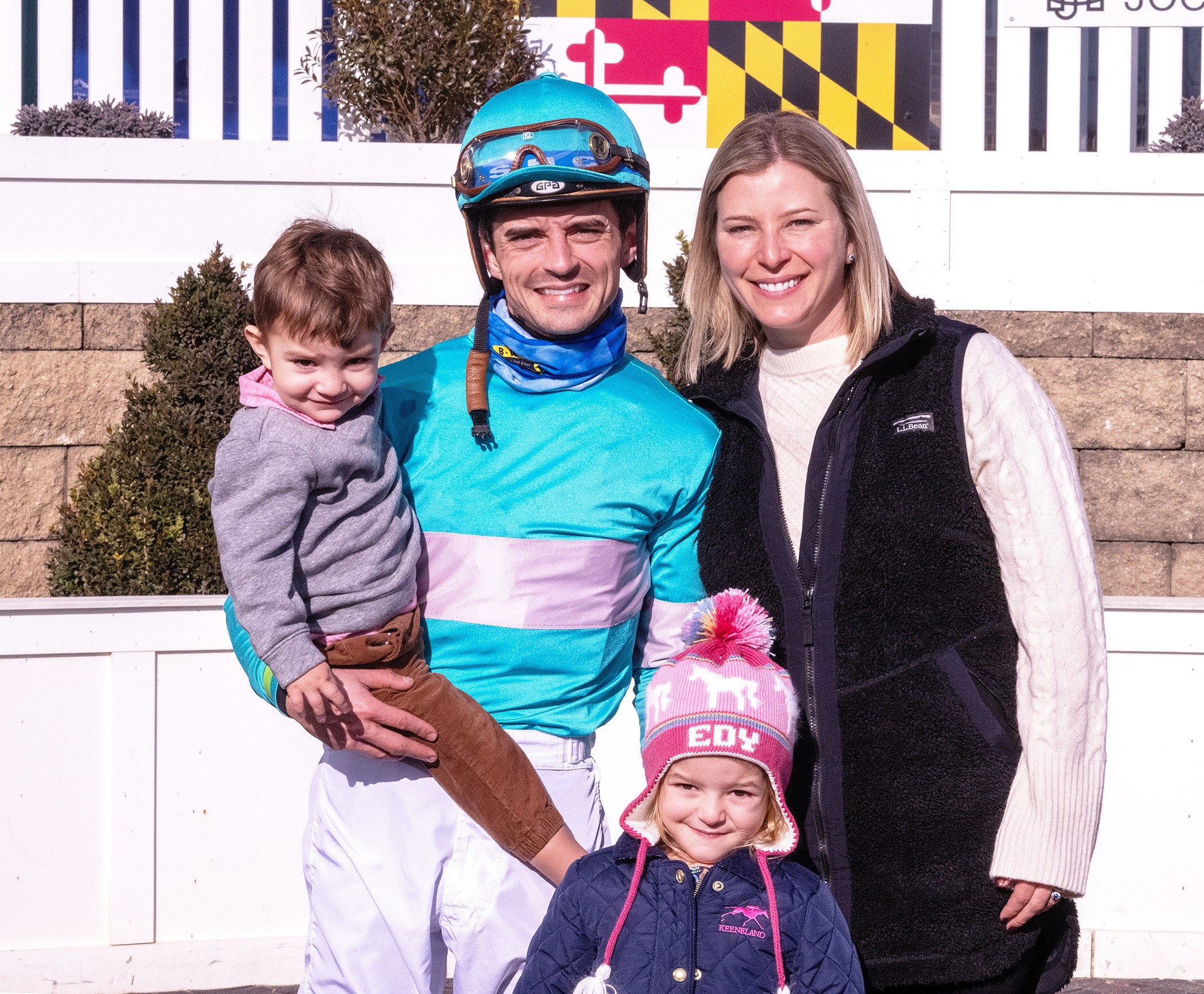 In this image provided by the The Maryland Jockey Club, husband and wife, jockey Sheldon Russell and trainer Brittany Russell, pose for a photo in the winner's circle with son Rye and daughter Edy, after Point Dume won the third race, Dec. 31, 2023, at Laurel Park in Laurel, Md.