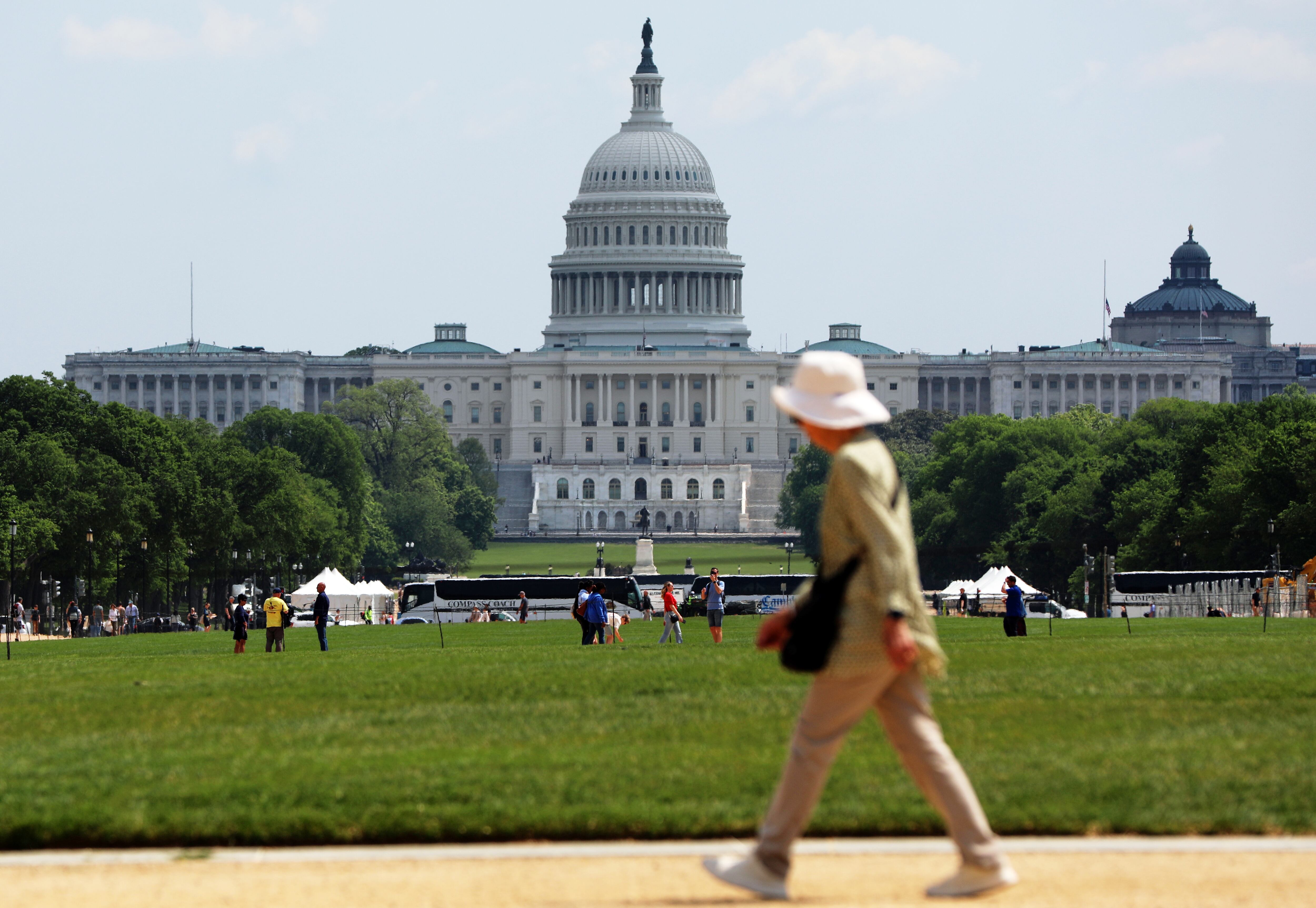 A woman walks on the National Mall, Thursday, April 23, 2026, in Washington. The U.S. Capitol is in the background.
