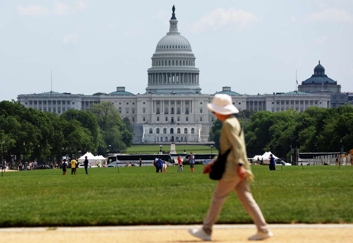 A woman walks on the National Mall, Thursday, April 23, 2026, in Washington. The U.S. Capitol is in the background.