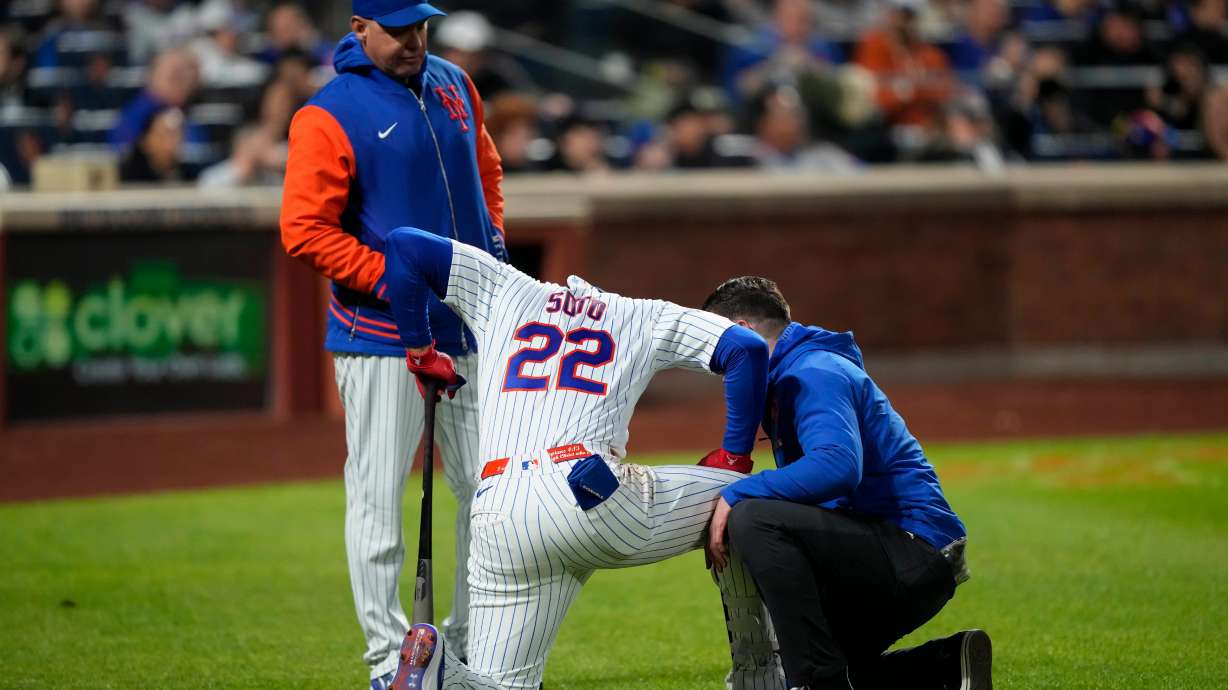 New York Mets designated hitter Juan Soto (22) reacts after getting hit by the ball on his ankle during the third inning of a baseball game against the Detroit Tigers, Wednesday, May 13, 2026, in New York.