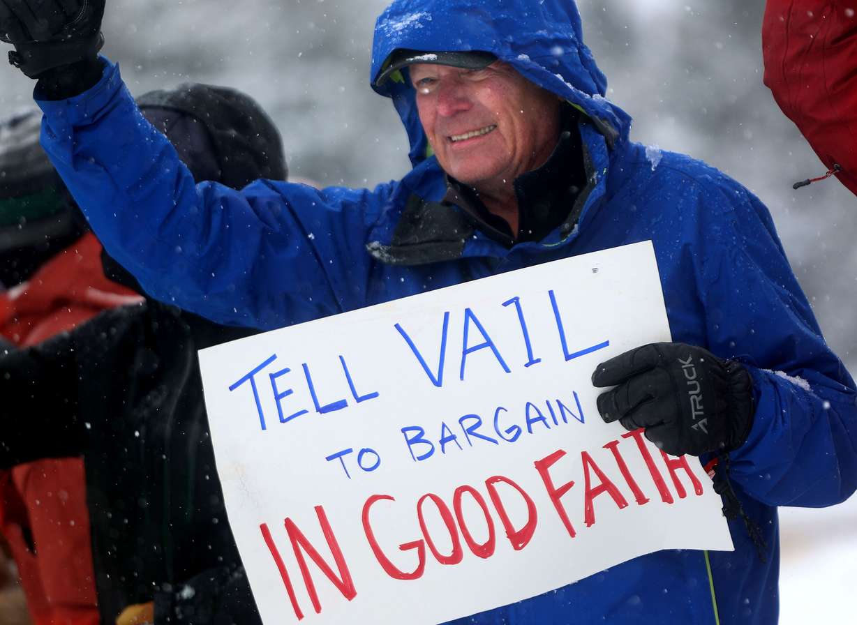 Ski patroller Cliff Ratcliffe acknowledges the honking horns of passing motorists while picketing in Park City on Dec. 27, 2024. The patrol union again filed for arbitration, accusing Vail Resorts of violating its collective bargaining agreement.