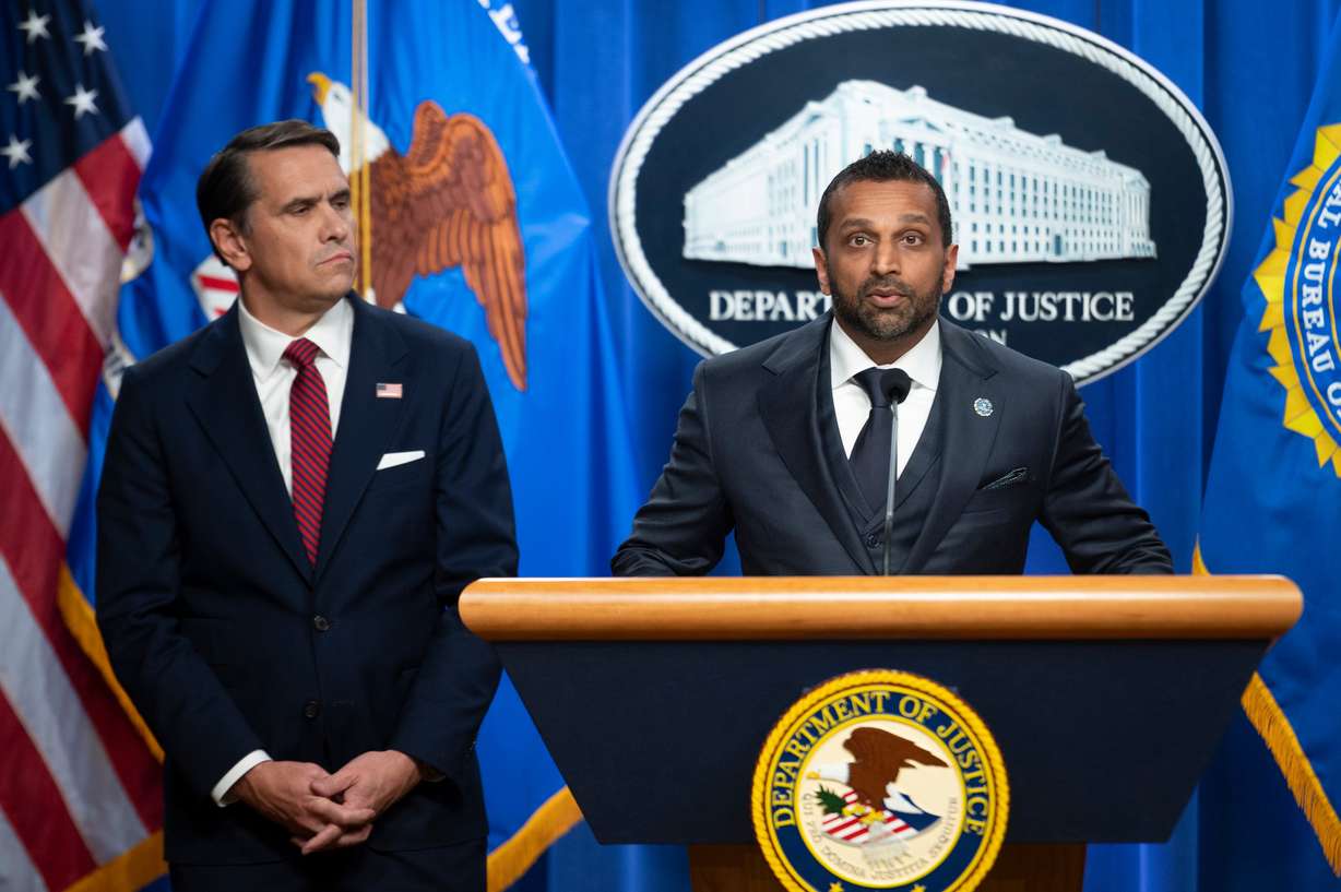 Acting Attorney General Todd Blanche looks on as FBI Director Kash Patel speaks about former FBI Director James Comey's indictment, at the Justice Department in Washington, April 28. A judge put off a decision in Comey's third criminal indictment on Friday.