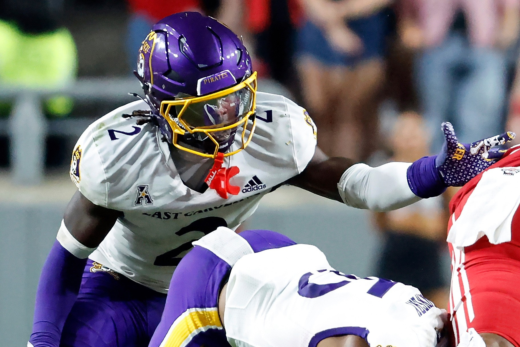 FILE - East Carolina's Ja'Marley Riddle (2) helps with a tackle during the second half of an NCAA college football game against North Carolina State in Raleigh, N.C., Aug. 28, 2025. 
