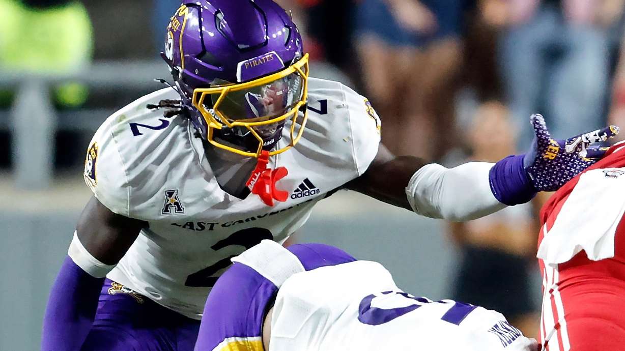 FILE - East Carolina's Ja'Marley Riddle (2) helps with a tackle during the second half of an NCAA college football game against North Carolina State in Raleigh, N.C., Aug. 28, 2025.