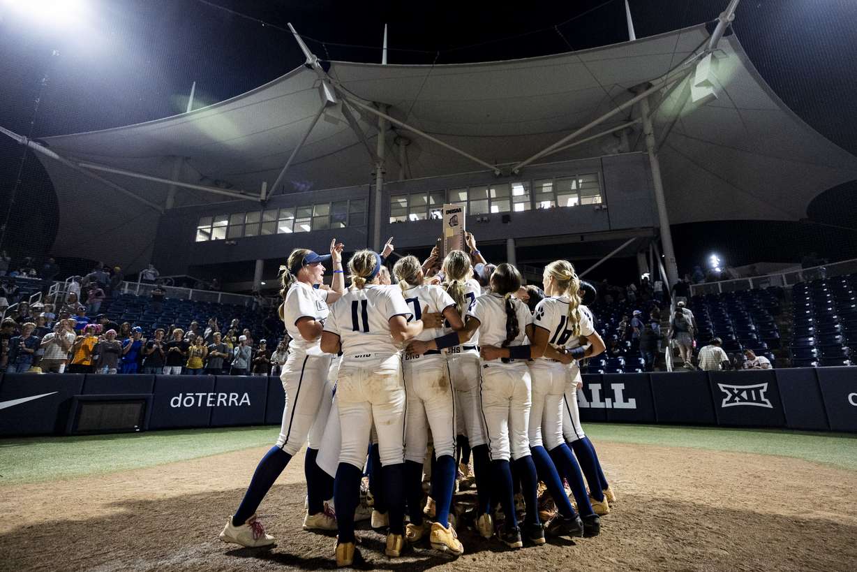Enterprise players celebrate around the championship trophy after defeating San Juan 7-4 in the 2A softball state championship game, held at Gail Miller Field in Provo on Saturday, May 9, 2026.