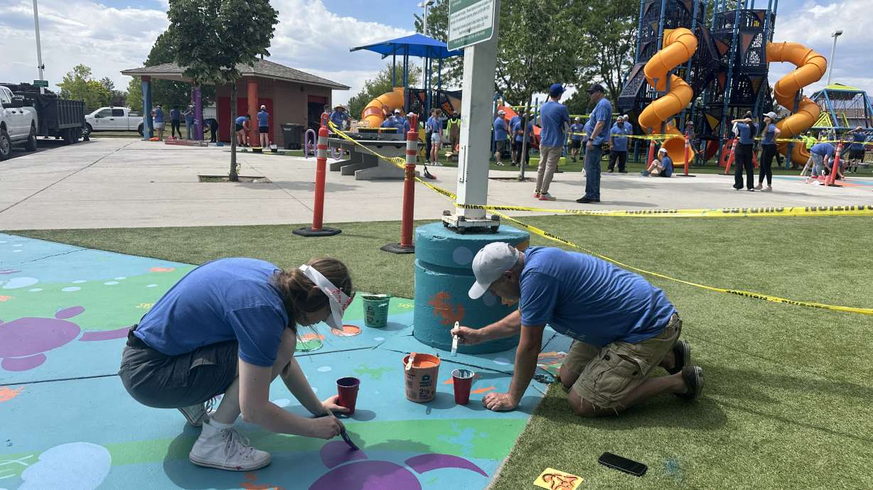 Employees from Integrity and community volunteers unite to revitalize the playground at Parkway Park in West Valley on Wednesday.