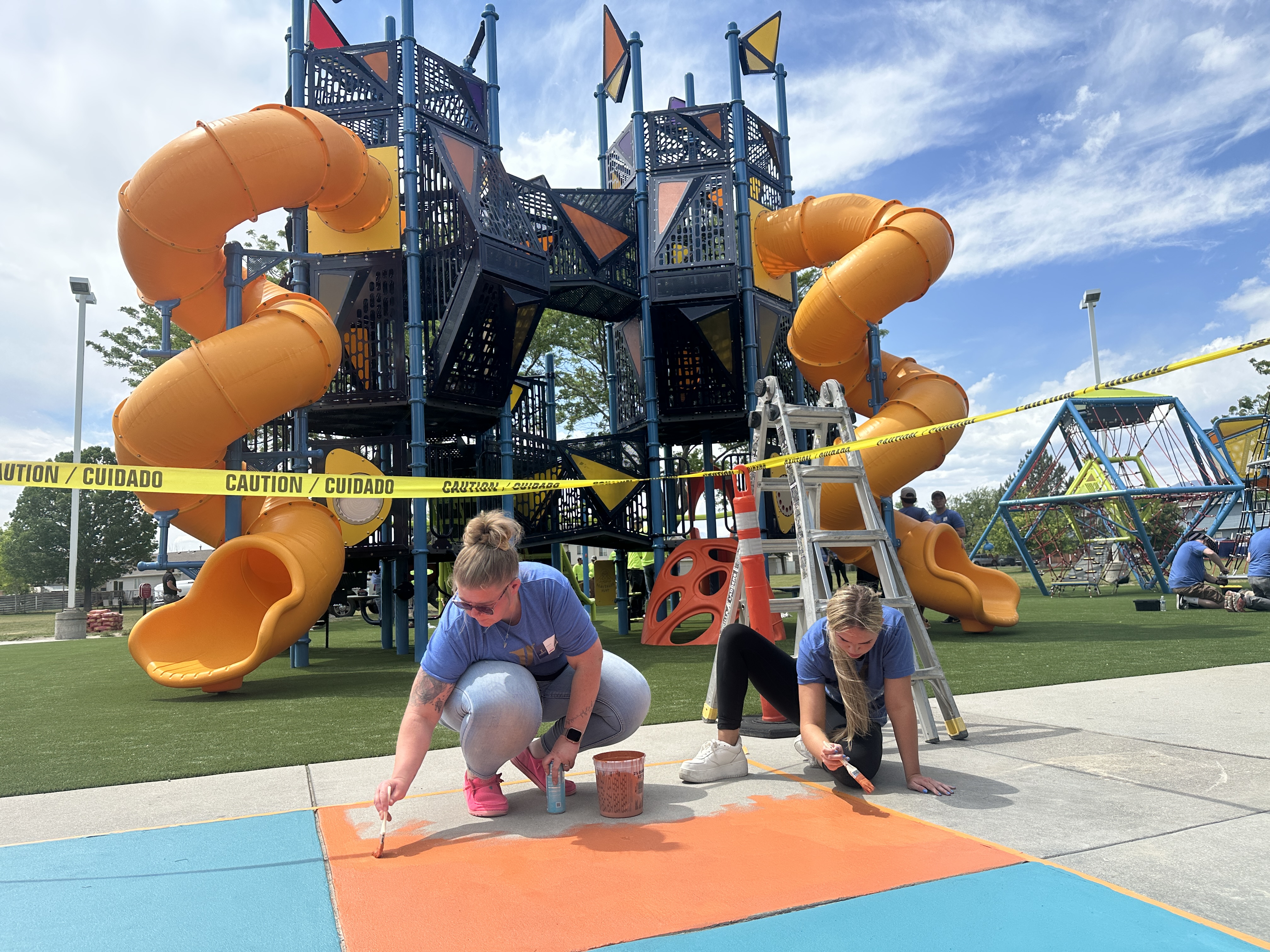Employees from Integrity and community volunteers unite to revitalize the playground at Parkway Park in West Valley on Wednesday.