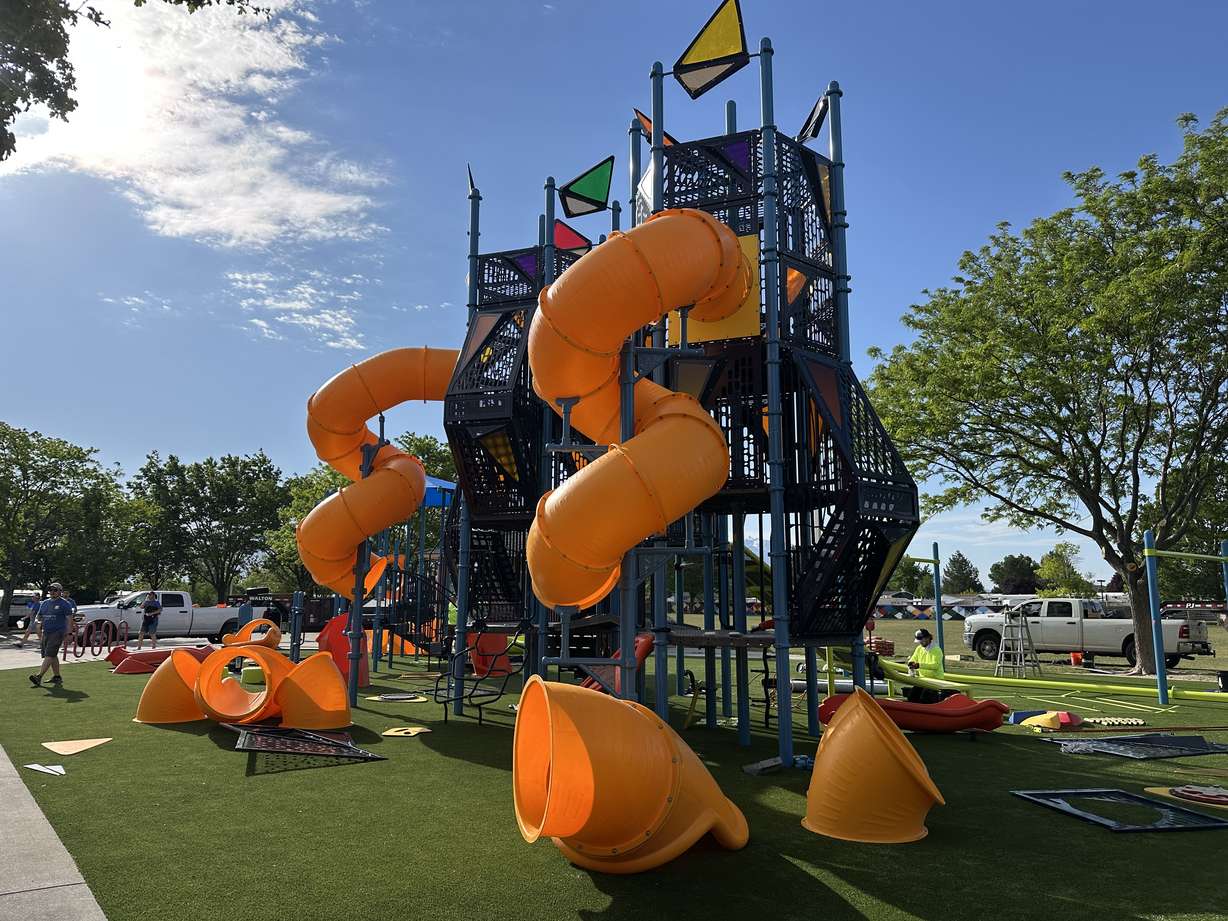 Employees from Integrity and community volunteers unite to revitalize the playground at Parkway Park in West Valley on Wednesday.