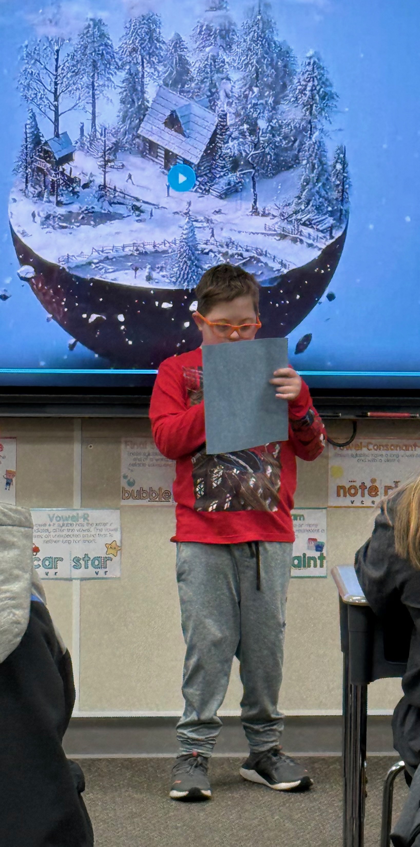 Ten-year-old Jude Garrett reads his snow globe story to his fourth-grade class at North Ogden Elementary School in North Ogden.
