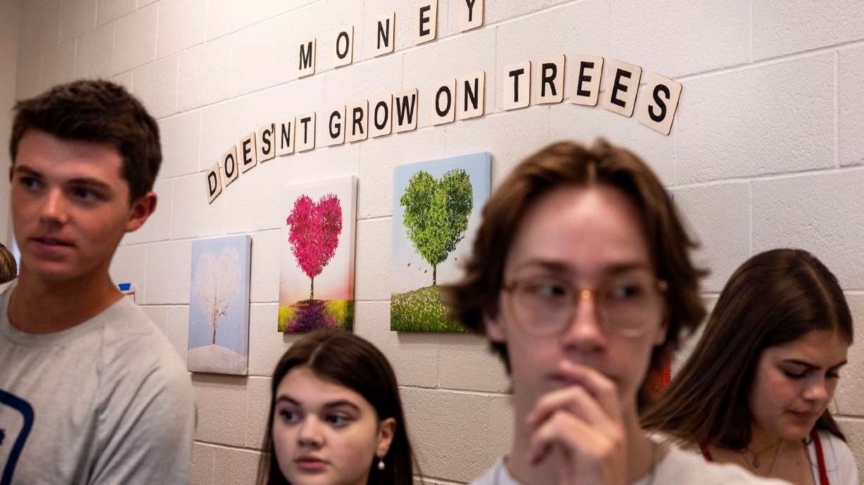 Students in Michelle Butler's financial literacy class participate in a “paycheck scavenger hunt” at Brighton High School in Cottonwood Heights on Thursday.