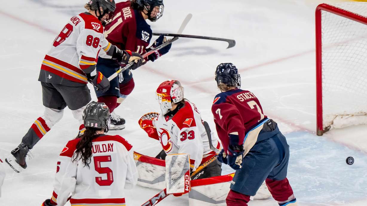 Montreal Victoire's Abby Roque (11) scores on Ottawa Charge goaltender Gwyneth Philips (33) during overtime of a PWHL playoff hockey game in Laval, Quebec, Thursday, May 14, 2026.