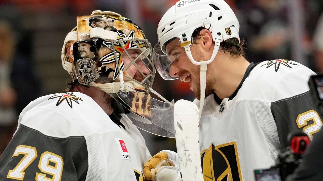 Vegas Golden Knights goaltender Carter Hart, left, and center Brett Howden congratulate each other after the Golden Knights defeated the Anaheim Ducks in Game 6 of a second-round NHL hockey Stanley Cup playoff series Thursday, May 14, 2026, in Anaheim, Calif.