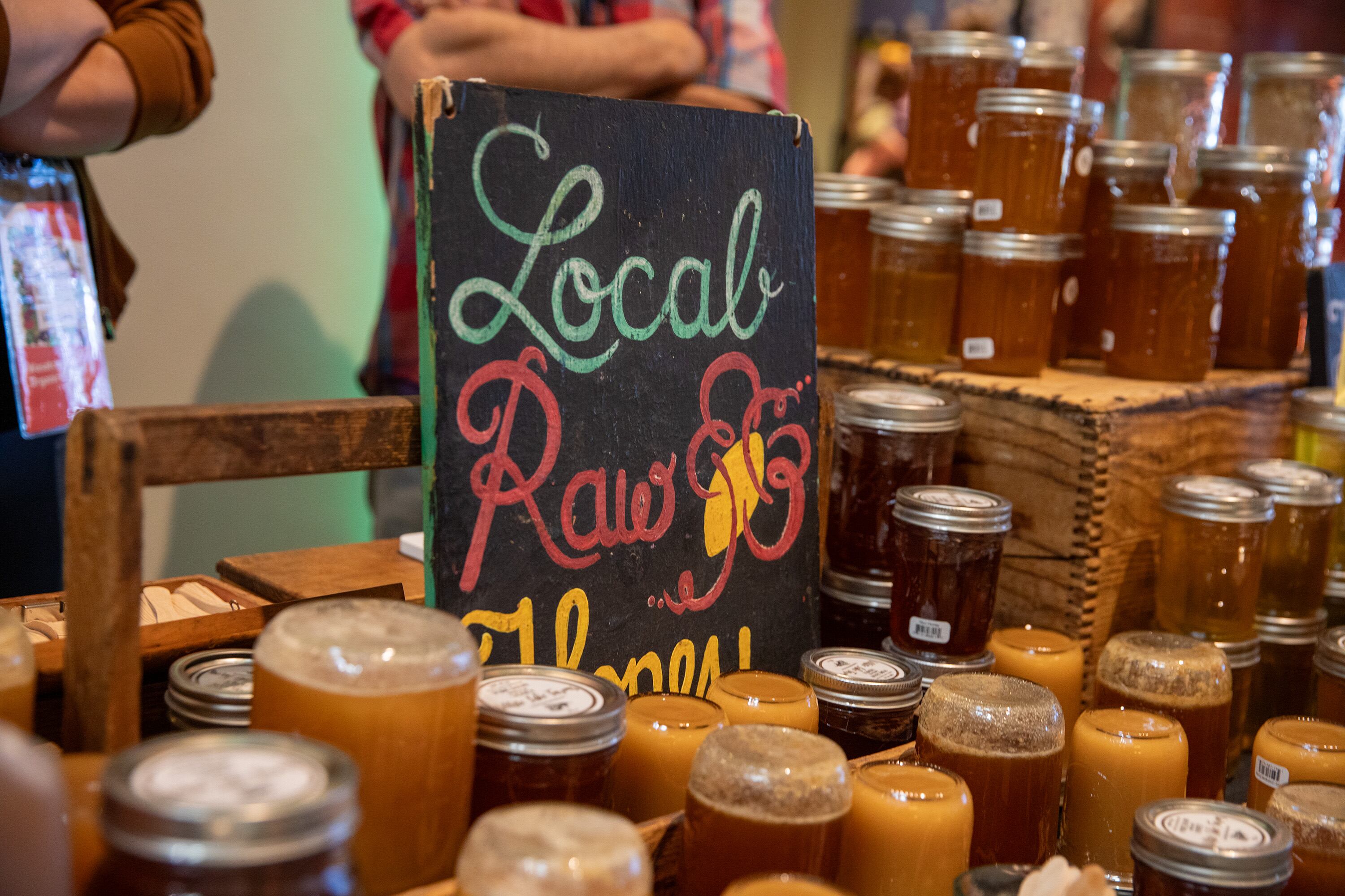 A table is covered in jars of local raw honey for sale and samples at the Utah Food Fest at the Natural History Museum of Utah. The festival is back at the museum through Sunday.