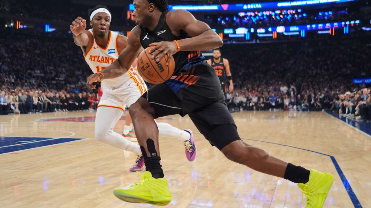 New York Knicks' OG Anunoby, right, drives past Atlanta Hawks' Onyeka Okongwu during the first half in Game 5 of a first-round NBA playoffs basketball series, Tuesday, April 28, 2026, in New York.
