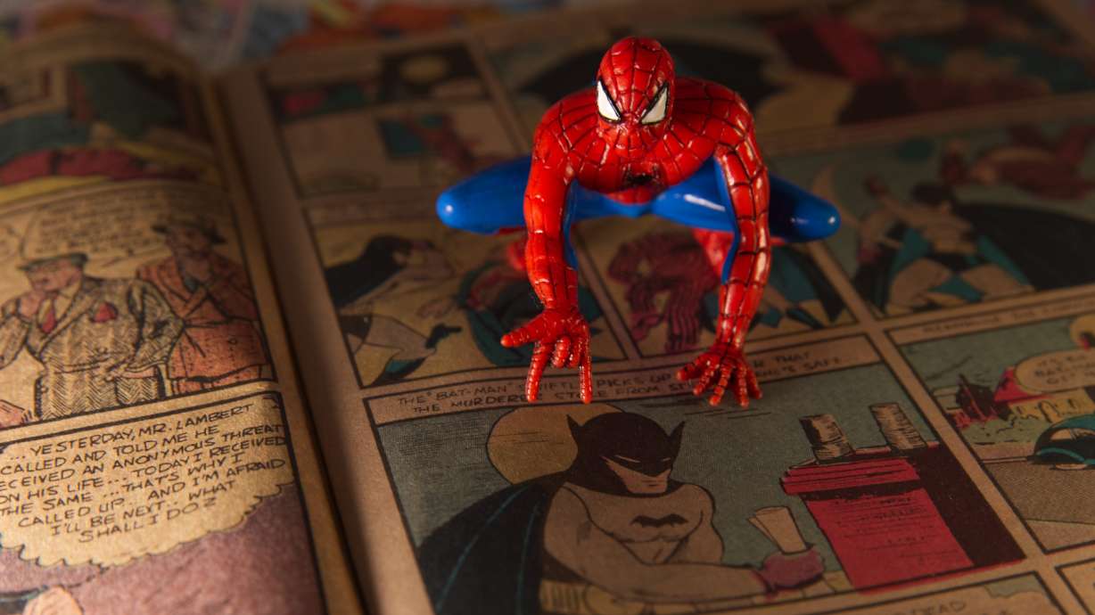A Spiderman figurine sits atop a facsimile copy of the May 1939 Detective Comics anthology series in Phoenix. This issue made history for including the debut of the Batman superhero in a story called "The Case of the Chemical Syndicate."