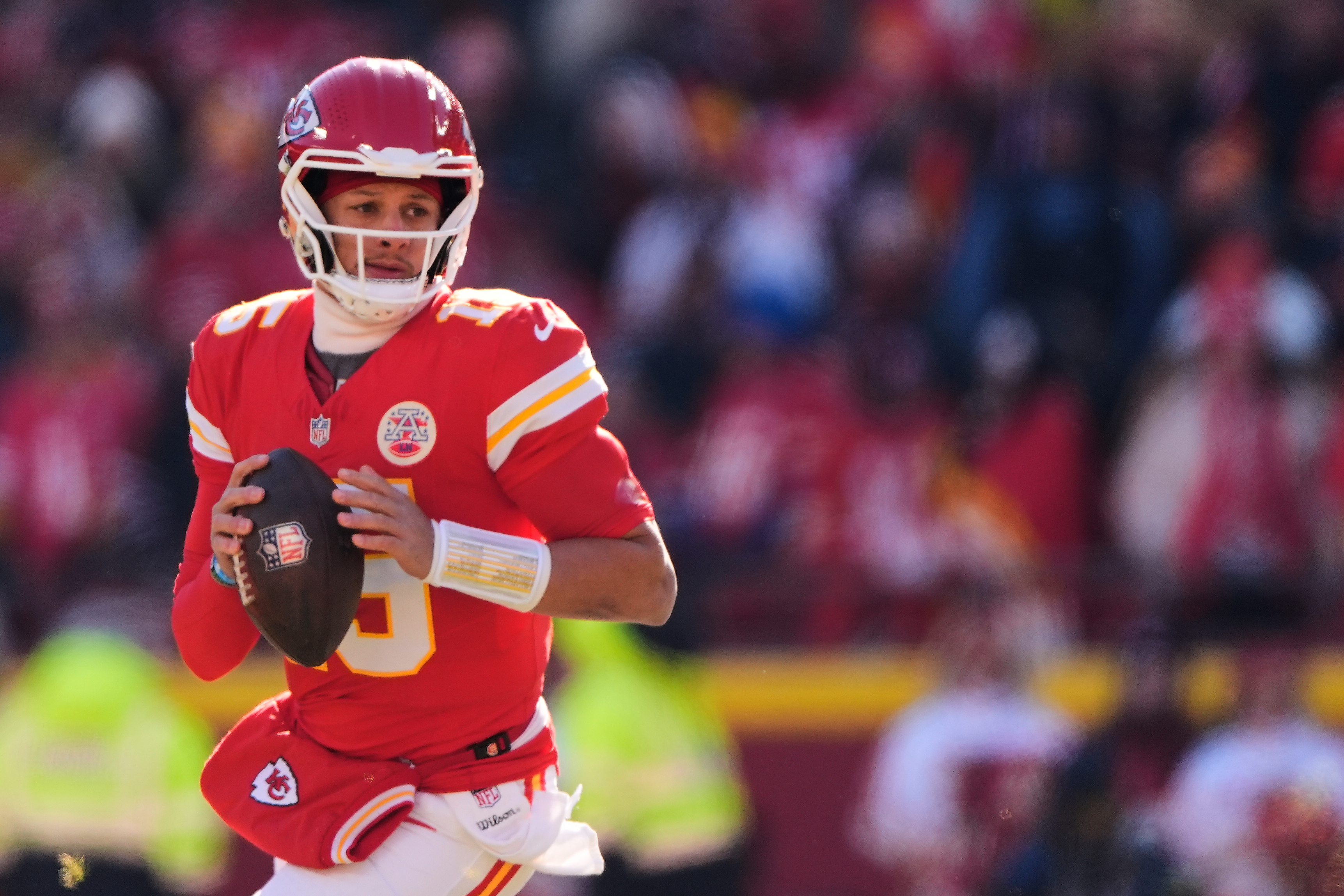 FILE - Kansas City Chiefs quarterback Patrick Mahomes looks to pass during the first half of an NFL football game against the Los Angeles Chargers, Dec. 14, 2025, in Kansas City, Mo. 