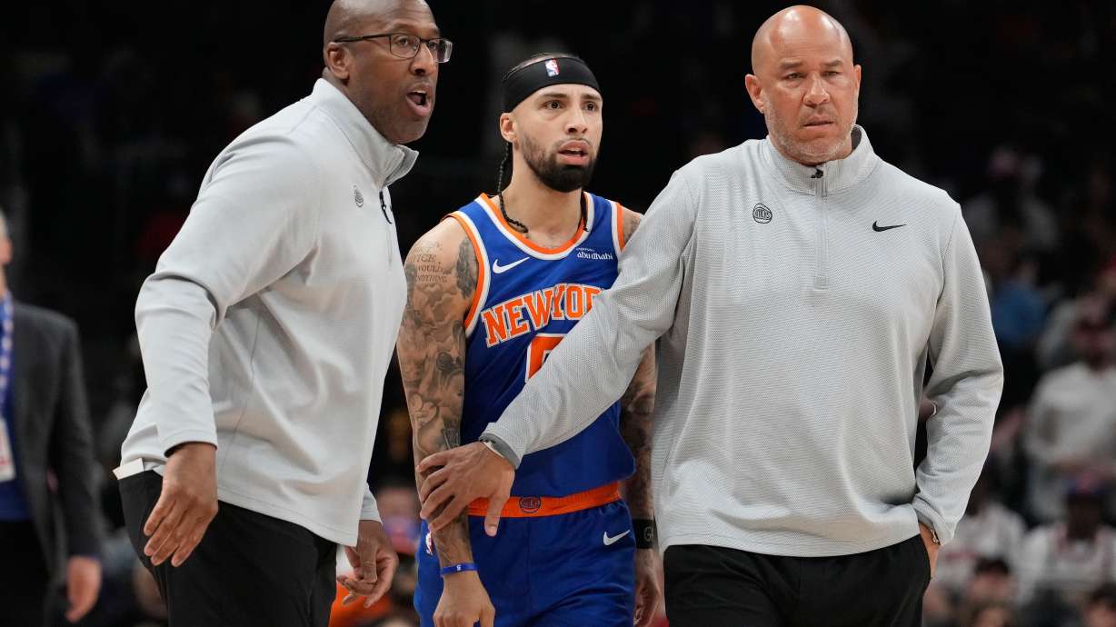 New York Knicks head coach Mike Brown holds back New York Knicks guard Jose Alvarado (5) with another coach during the first half of Game 4 in a first-round NBA playoffs basketball series against the Atlanta Hawks Saturday, April 25, 2026, in Atlanta.