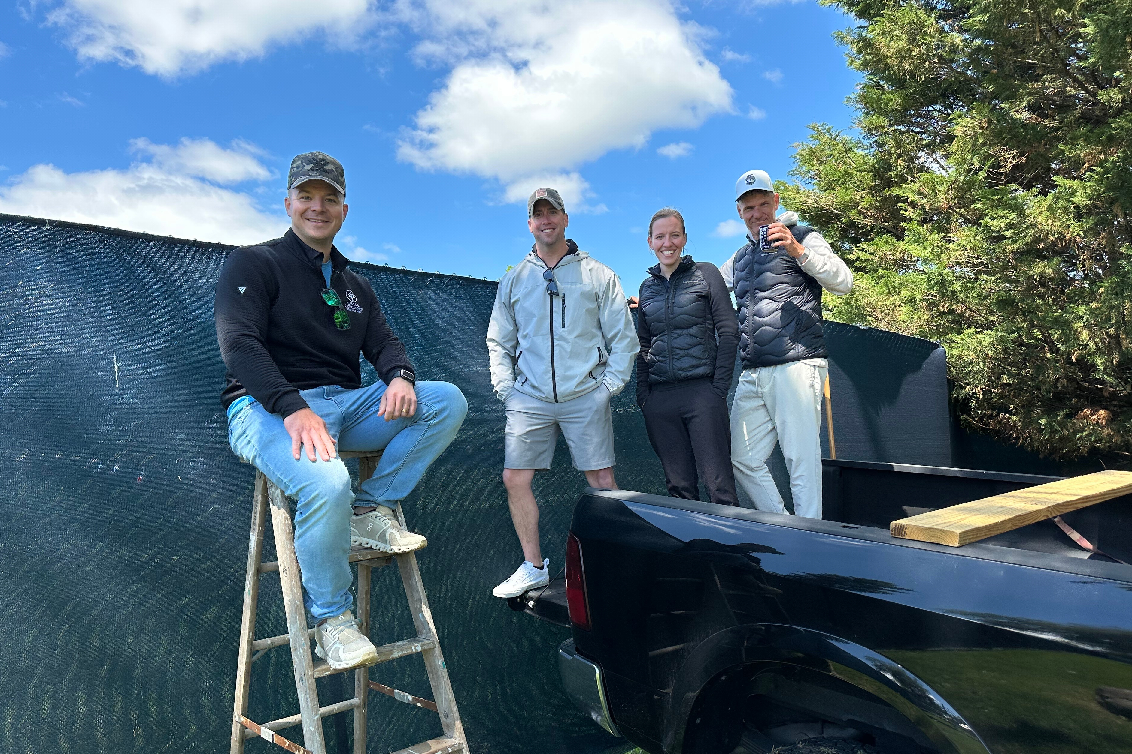 Golf fans pose for a photo while watching the PGA Championship golf tournament from pickup trucks and ladders from neighborhood homes outside Aronimink Golf Club, Friday, May 15, 2026 in Newtown Square, Pa. 