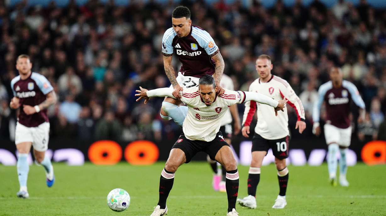 Liverpool's Virgil van Dijk, front, tries to block Aston Villa's Morgan Rogers from the ball during the English Premier League soccer match between Aston Villa and Liverpool in Birmingham, England, Friday, May 15, 2026.