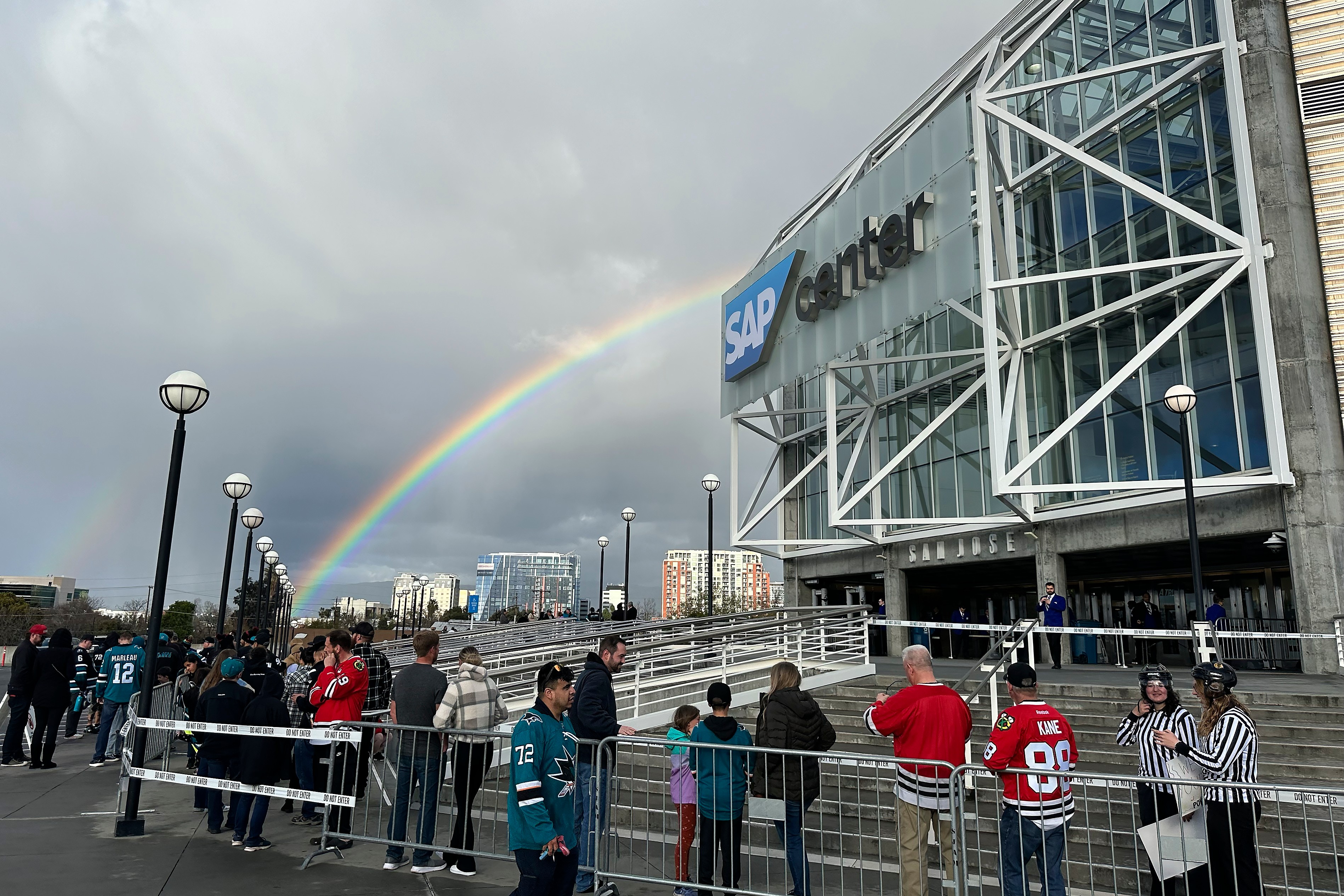 FILE - A rainbow is shown as fans line up outside SAP Center at San Jose before an NHL hockey game between the Chicago Blackhawks and the San Jose Sharks in San Jose, Calif., March 23, 2024. 
